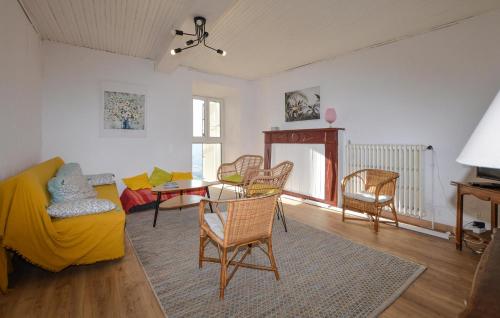 a living room with a yellow couch and chairs at 3 Bedroom Awesome Apartment In Olmeto in Olmeto