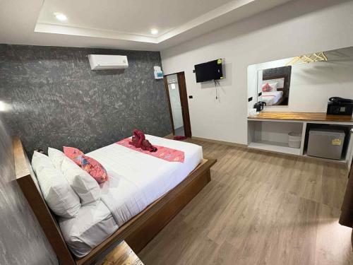 a bedroom with a bed and a desk in it at Stay at Lanta Bungalow in Ko Lanta