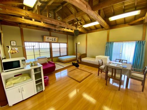 a living room with a couch and a table at Wakihonjin in Kikugawa