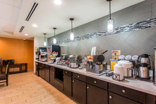 a large kitchen with a counter with many appliances at Comfort Inn & Suites Cookeville in Cookeville