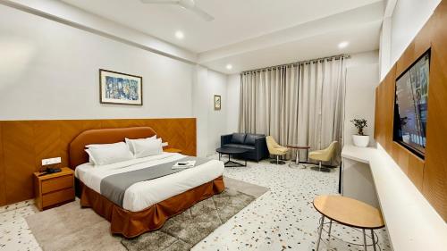 a hotel room with a bed and a television at Hotel Citadel Inn in Indore