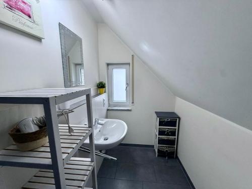 a bathroom with a sink and a toilet in a room at Deluxe Apartment Diamond in Friedrichshafen