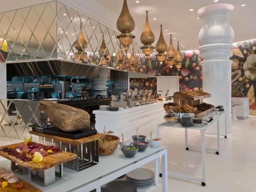a bakery with many different types of food on display at Mondrian Doha in Doha