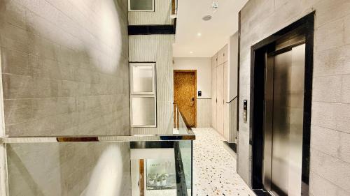 a hallway with a glass counter in a house at Hotel Citadel Inn in Indore