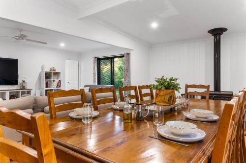 a dining room with a wooden table and chairs at Elizabeths House in Ballandean