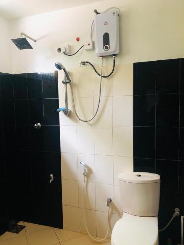 a bathroom with a shower with a toilet at Villa Elora in Bandarawela