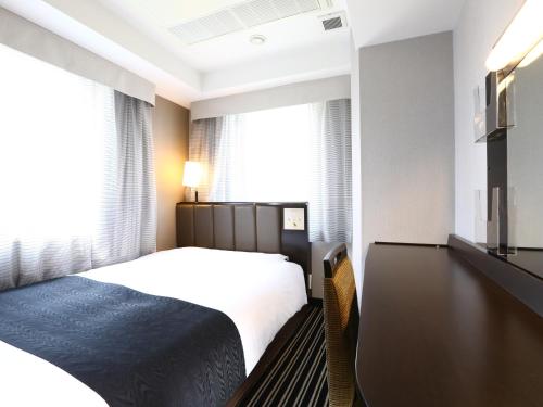 東京にあるアパホテル＜銀座京橋南＞（東京駅八重洲南）のベッドと窓のあるホテルの部屋
