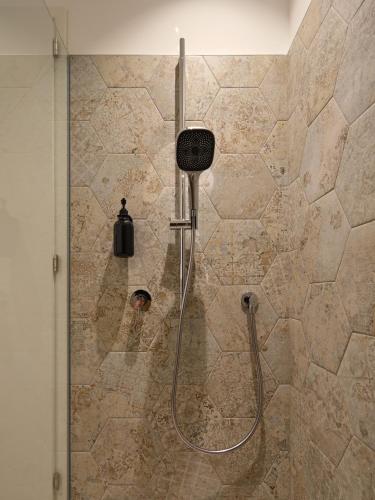 a shower in a bathroom with a glass door at LIMIX Stays in Appiano sulla Strada del Vino