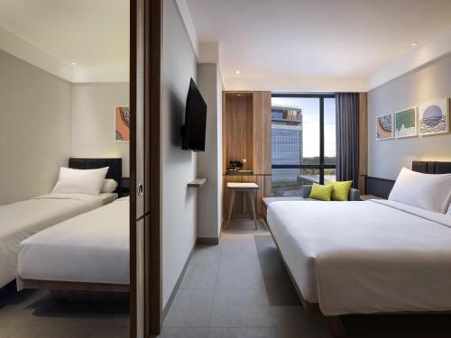 Ένα ή περισσότερα κρεβάτια σε δωμάτιο στο ibis Yogyakarta International Airport Kulon Progo