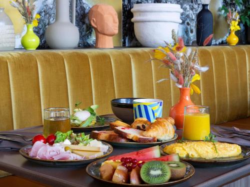 a table with four plates of food on it at Pullman Lyon in Lyon