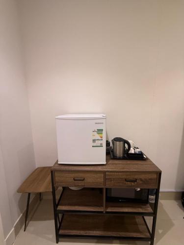 a white appliance sitting on top of a wooden table at شقة جديدة ومميزة بحي الملقا in Riyadh