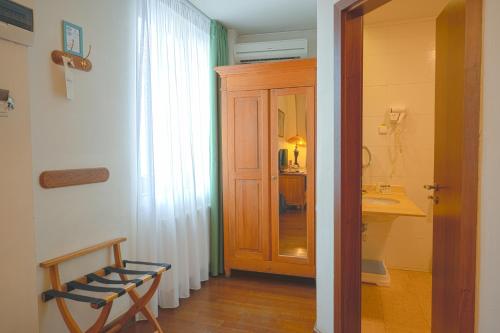 a bathroom with a sink and a wooden door at Rembrandt Old Town in Bucharest