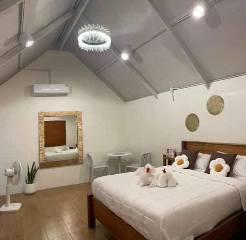 a bedroom with a bed with two stuffed animals on it at Chamin Longbeach Bungalow in Ko Lanta