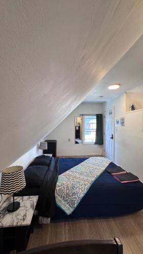 a bedroom with a large bed in a room at Loft Private Studio -- Washer and Dryer -- Near Boston Transit in Malden