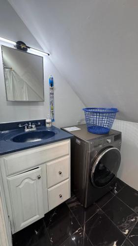 a bathroom with a sink and a washing machine at Loft Private Studio -- Washer and Dryer -- Near Boston Transit in Malden