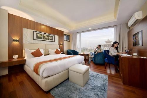 Postel nebo postele na pokoji v ubytování Kumari Boutique Hotel