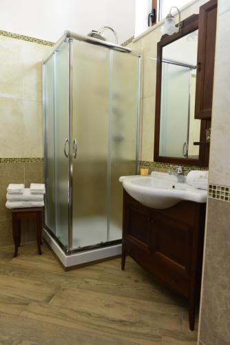 a bathroom with a glass shower and a sink at Il Castello in Orneta