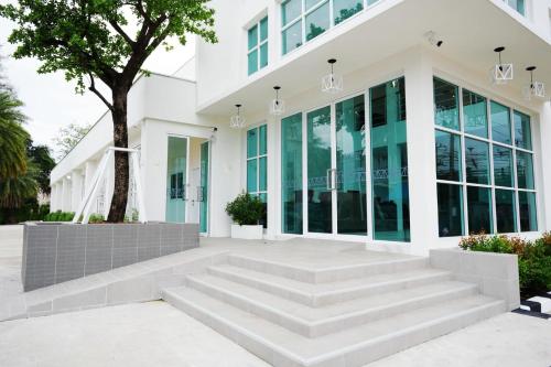 a white building with stairs in front of it at Matini Hotel BU