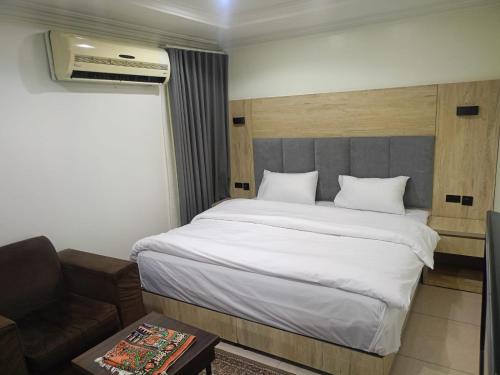 a bedroom with a large white bed and a couch at العييري للشقق المخدومة in Dammam