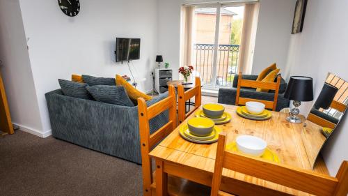 a living room with a table and a couch at Greenings Apt Warrington - 2 Bed with FREE off road Parking & Wifi in Warrington
