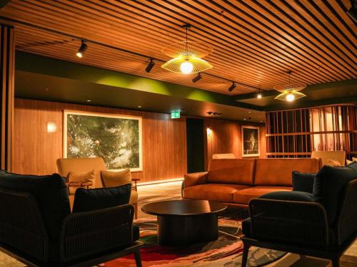 a living room with a couch and a table at Peppers Gladstone in Gladstone