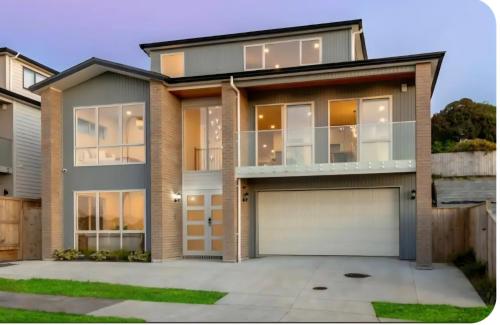 a house with a garage in front of it at Bula Suite Flatbush New Zealand - Granny Flat in Auckland