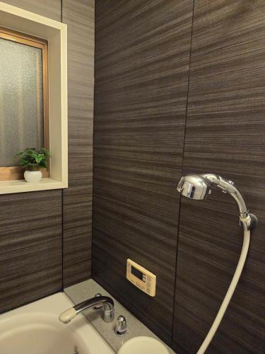 a bathroom with a shower and a sink at 一棟貸 風kaze in Ogaki