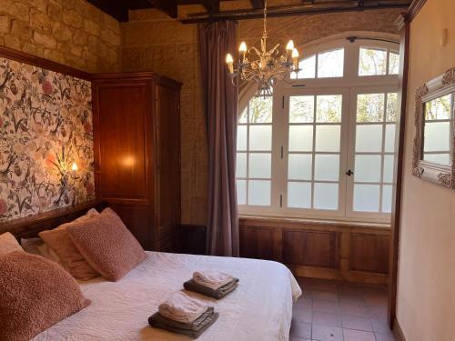 Postel nebo postele na pokoji v ubytování La Closerie de Baneuil