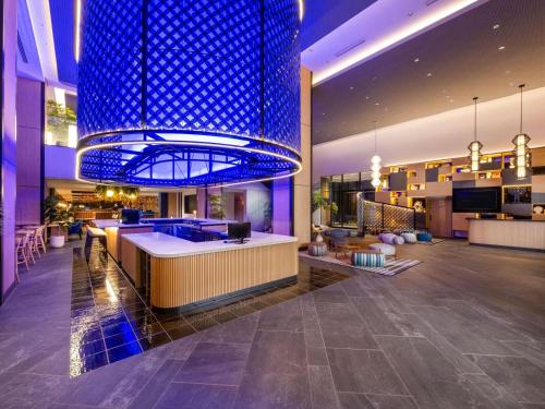 a lobby with a large blue chandelier in a building at Novotel Nara in Nara