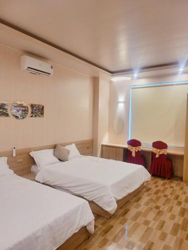 Postel nebo postele na pokoji v ubytování hottel hung phat