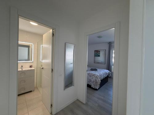 a room with a bedroom with a bed and a mirror at The White Pearl Marbella in Marbella