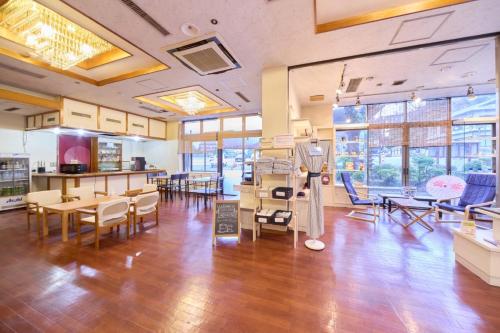 a large room with wooden floors and tables and chairs at 日光いろは in Nikko