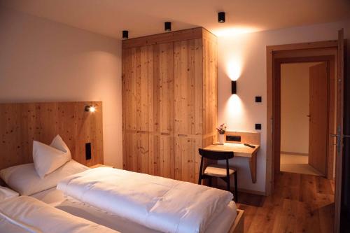 En eller flere senge i et værelse på Noe Dolomite Residence