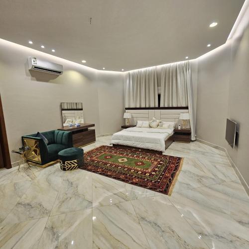 a bedroom with a bed and a couch and a chair at استراحة الزهراء in Jeddah