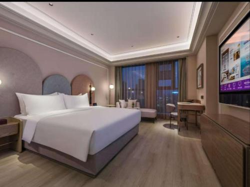 Ένα ή περισσότερα κρεβάτια σε δωμάτιο στο Mercure Nantong Railway Station