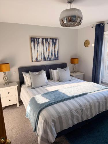 a bedroom with a large bed with two night stands at Cathedral Quarter House with free Secure Driveway Parking for 2 Cars in Lincoln