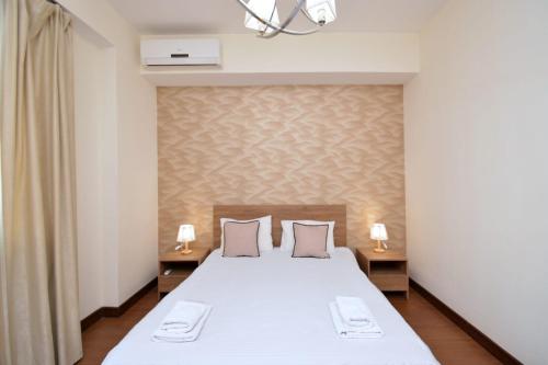 Ένα ή περισσότερα κρεβάτια σε δωμάτιο στο Lavelo Apartments