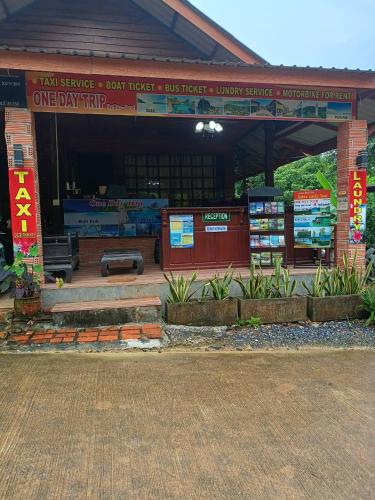 a building with a sign that reads one day trial at Dahla Lanta Hut in Ko Lanta