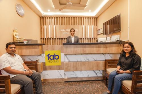 a group of three people sitting in a waiting room at FabHotel MRV Inn in Chennai
