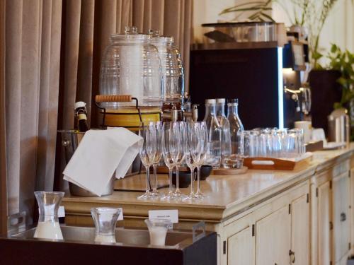 a counter with wine glasses and bottles on it at The Mozart Prague in Prague