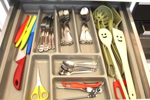 a tray filled with utensils and utensils at Apartment Promenada in Poděbrady