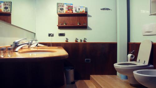 a bathroom with a sink and a toilet at A Casa in Ravenna