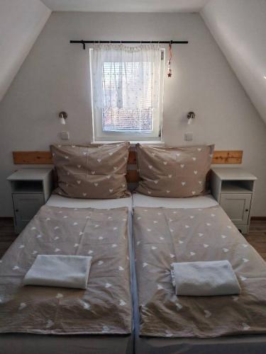 a bedroom with two beds and a window at Wellness chata BABÍ VRCH in Trojanovice