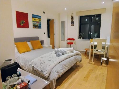a bedroom with a bed and a table and a dining room at Fantastic location private Deluxe Ensuite bathroom Shoreditch Hoxton spitalfields Liverpool st London Bridge city 2 Rooms luxury Doubles for 5 guests in London
