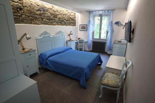 マナローラにある5 TERRE PELAGOSのベッドルーム(青いベッド1台、椅子付)