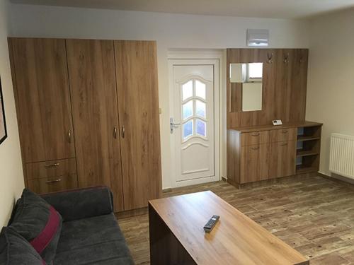 a living room with a couch and a table and a door at Apartment Šárka in Strupčice