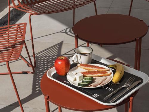 a tray with food and fruit on a table at ibis budget Madrid Albasanz in Madrid