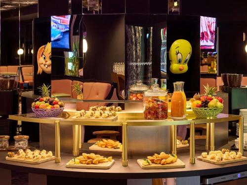 a table filled with plates of food and fruit at Mama Shelter Zurich in Zürich