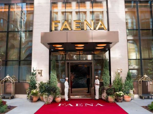 two men standing in front of a hotel lobby at Faena New York in New York