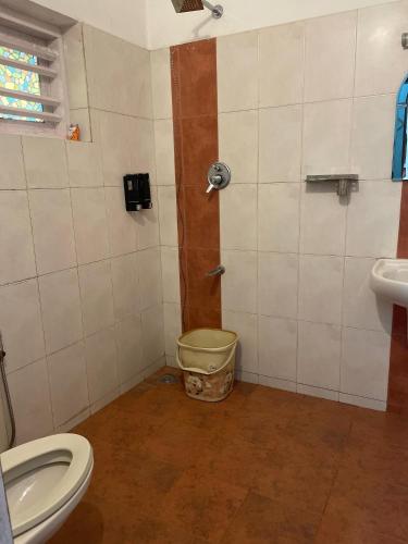 a bathroom with a toilet and a sink at Raaga on the Beach in Kannur